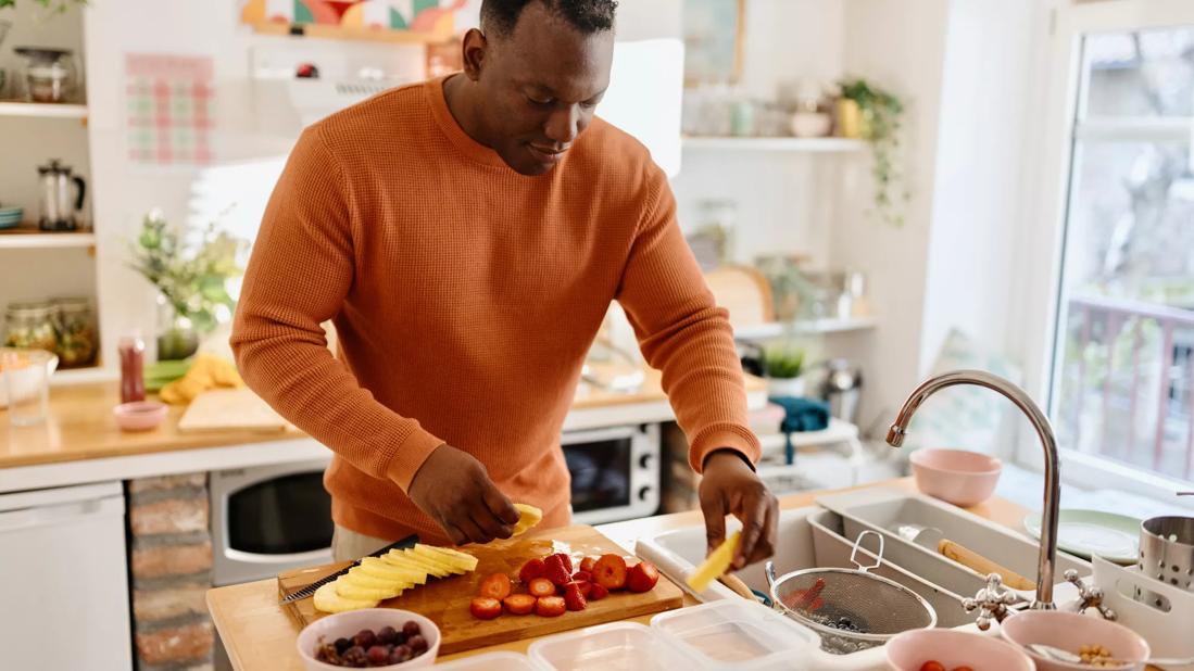 Person prepping different foods in kitchen