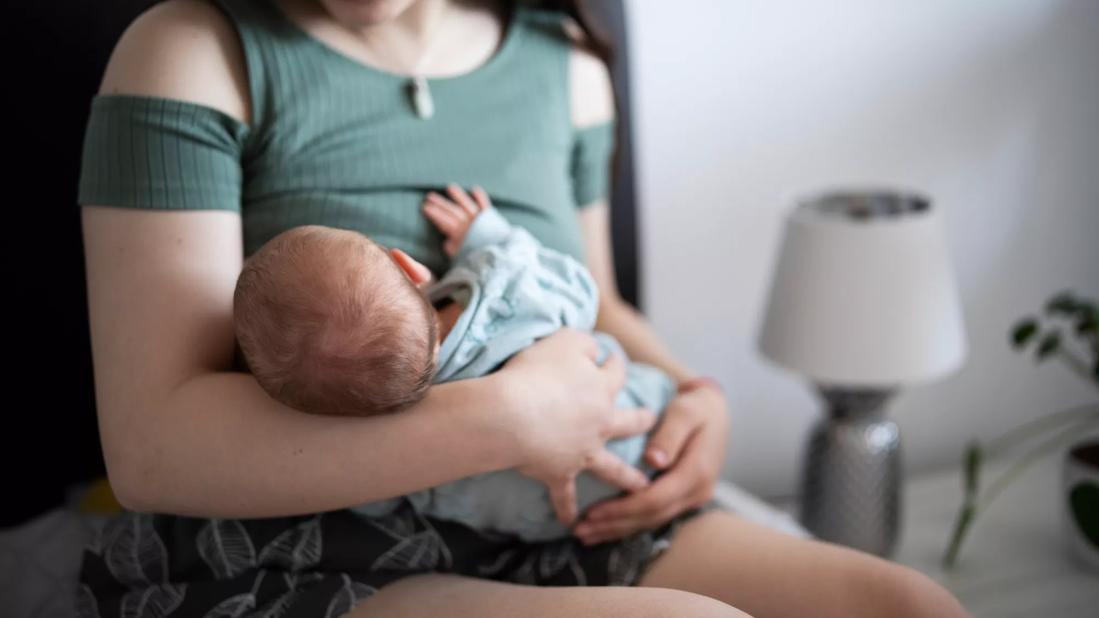 Female breast feeding baby