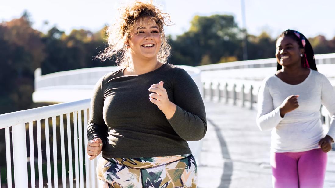 Female and friend jogging outside