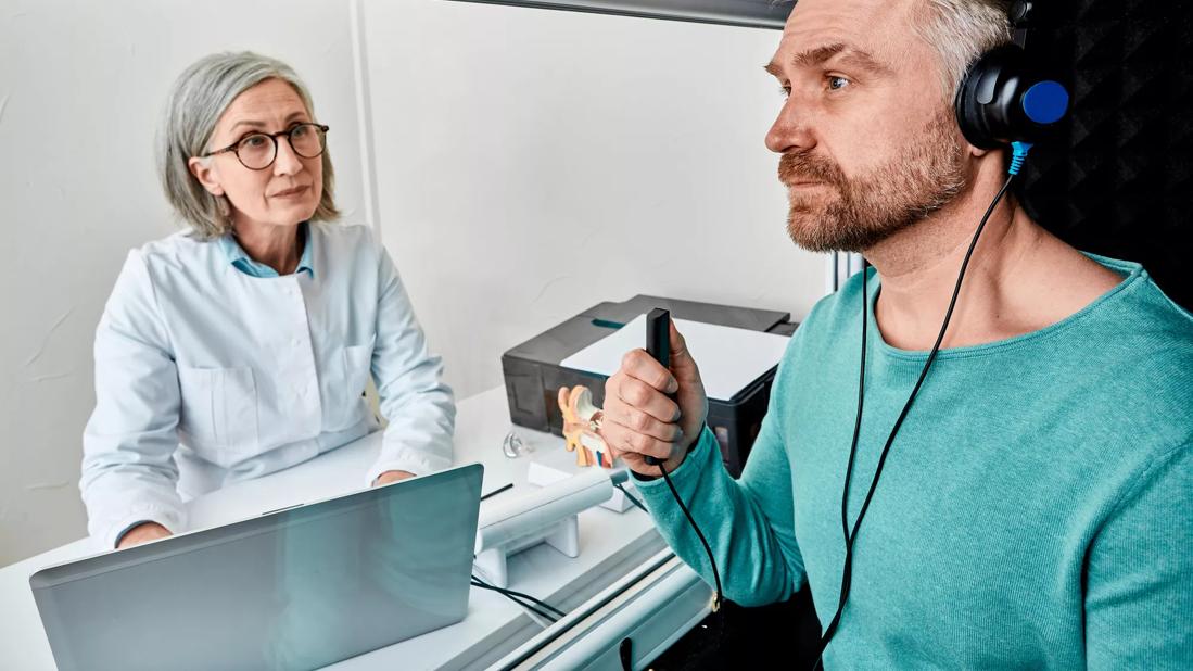 Person getting an audiogram, with technician