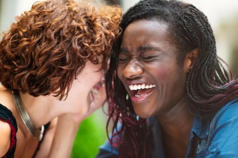 Two friends laughing together