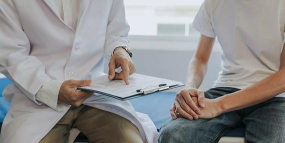 Healthcare provider discussing lab results with a younger man