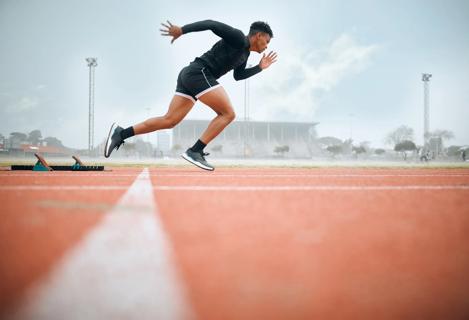 Runner sprinting from starting line on track