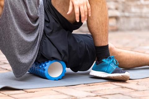 Person stretching on foam roller