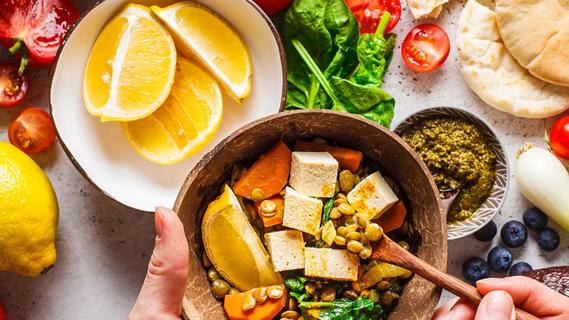 Oranges in bowl and tofu meal in bowl