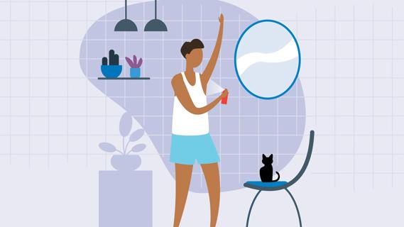 Person spraying antipersperant into their armpit at home, kitty on chair