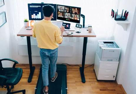 Person working at a treadmill desk.