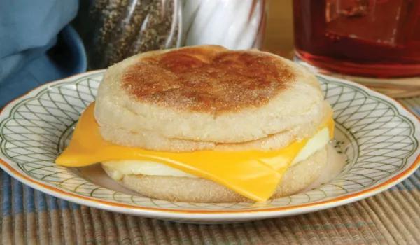 Egg and cheese English muffin sandwich on plate