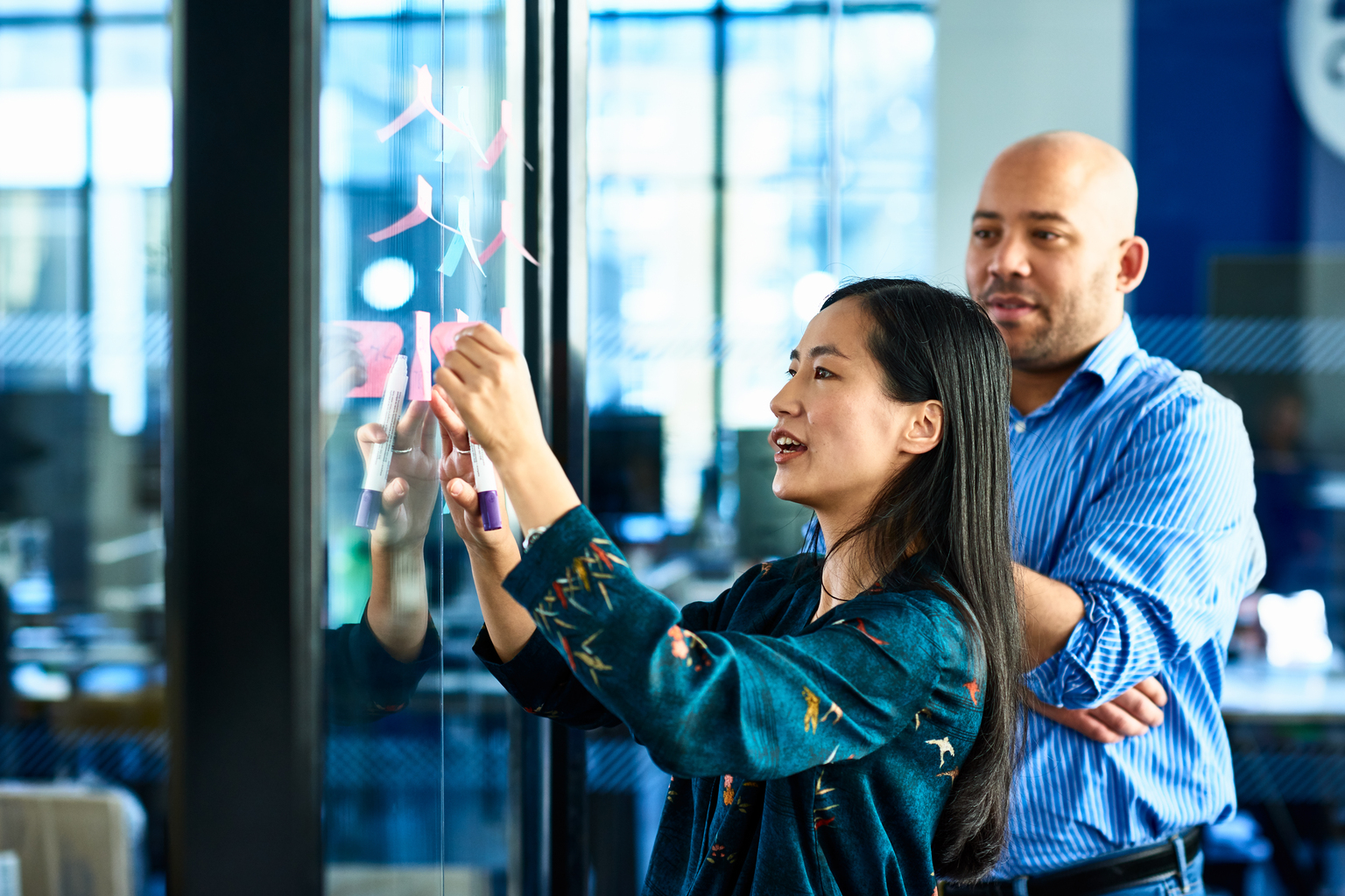 A female coworker figuring out strategies on post-it notes