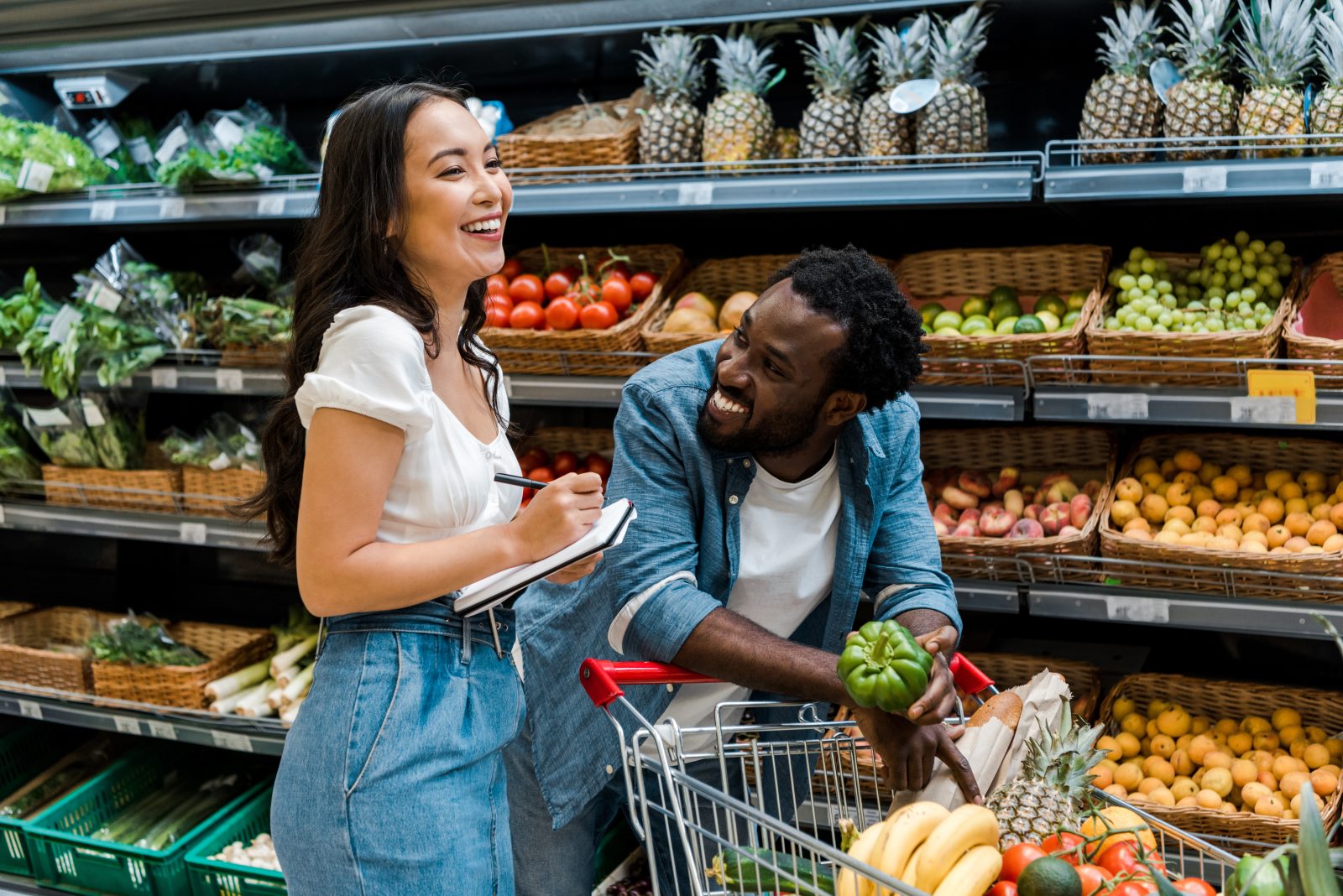 Man and woman in the produce section of the grocery store