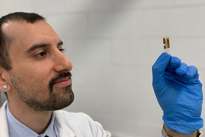 Hossein Alijani, co-lead author of a paper on the research, inspects a MXene membrane