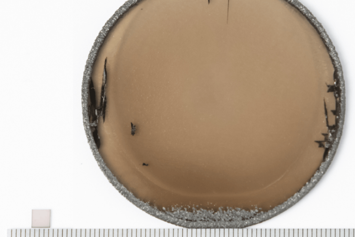 An ultra-pure diamond wafer (right) measuring 5 cm (2 in) in diameter that could be used for high-density data storage. The small square to the left is the usual size of diamond wafers possible using older manufacturing techniques.