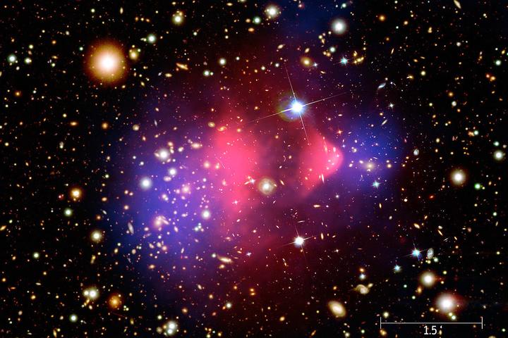 A composite image showing galaxies in optical light, X-ray emissions in pink and invisible mass – or dark matter – in blue