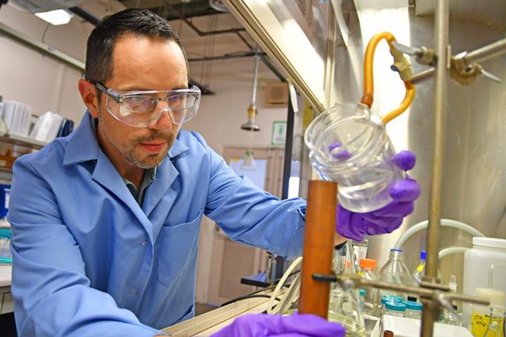 Explosives chemist David Chavez pours an example of melt-castable explosive into a copper mold at Los Alamos National Laboratory’s Technical Area 9