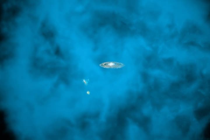 An artist's impression of the Milky Way galaxy (center), surrounded by the dust and gas of the circumgalactic medium (blue)