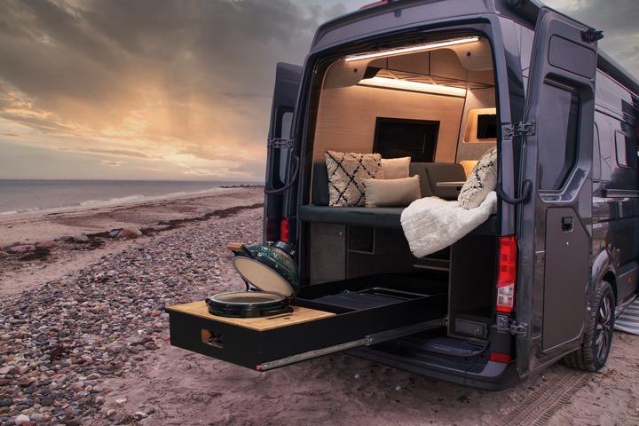 The unequivocal highlight of the Loef camper van package is the rear slide-out Big Green Egg grill