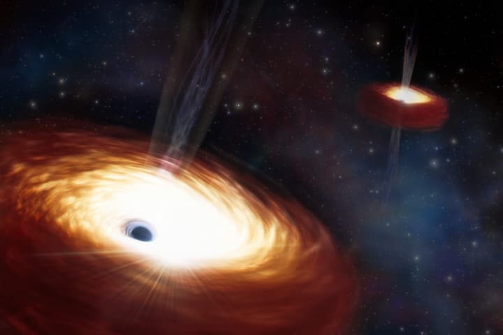 An artist's impression of a pair of supermassive black holes that have been locked in foreplay for 3 billion years