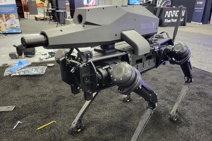 Ghost Robotics presented a back-mounted gun attachment by Sword Defense Systems for its Vision 60 robot at the NDIA Future Force Capabilities expo in Georgia