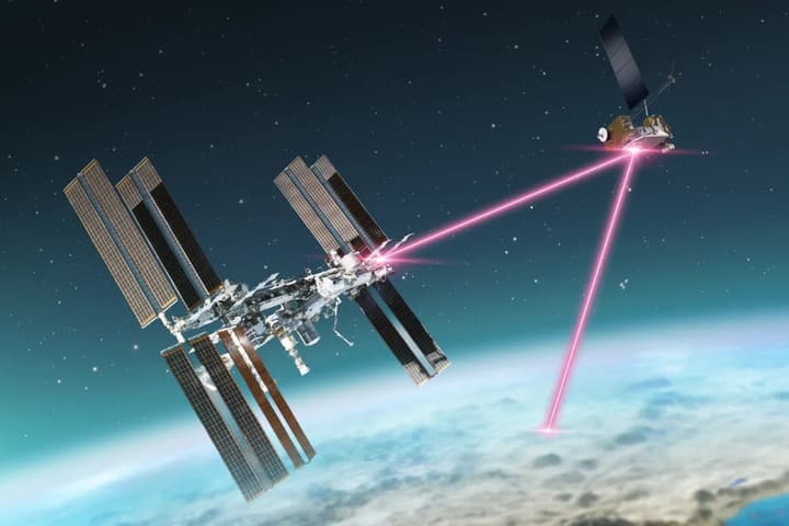 An artist's impression of the International Space Station beaming data via laser to the LCRD and down to ground stations