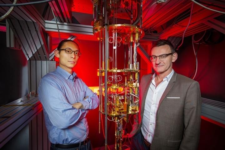 Dr Henry Yang and Professor Andrew Dzurak of UNSW, with the kind of large, expensive dilution refrigerator currently used to supercool quantum computing qubits. Their new hot qubit technology could remove the need for such bulky, expensive cooling systems