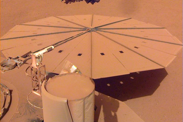 The dust-covered solar panels of the InSight lander