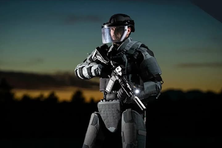 The ExoM Up-Armoured Exoskeleton reportedly redistributes up to 70% of the overall load from the wearer's shoulders down to the ground, plus it can withstand hits from 7.62 × 39-mm rounds