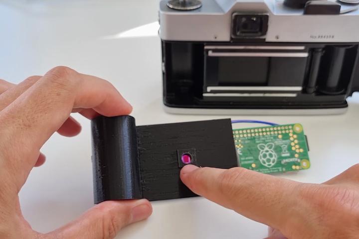 The 3D-printed case is home to a Li-Po battery, step-up converter, Pi camera module, and Pi Zero W – which help bring digital camera capabilities to an old film camera from the 1970s