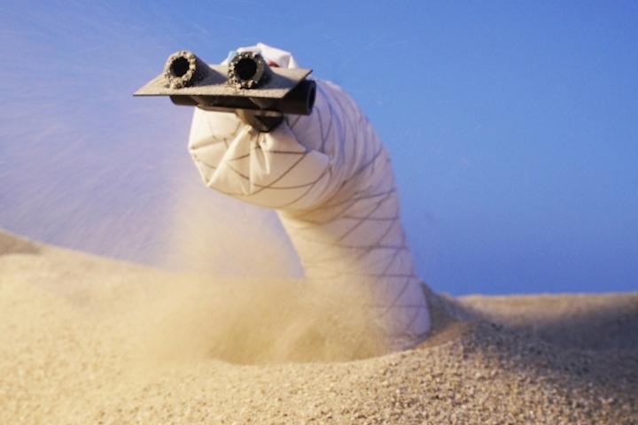 The new sand-burrowing robot has air jets in its front to blast sand out of its path, and a wedge-shaped head to help it steer