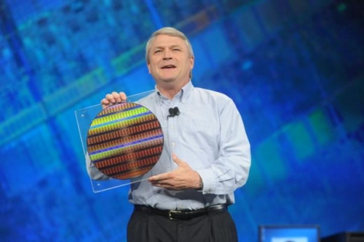 Bob Baker, VP of technology and manufacturing displays a silicon wafer containing the world's first working chips built on 22nm manufacturing technology.