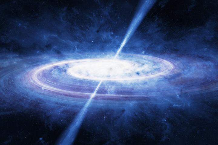 An artist's impression of a quasar, or an active supermassive black hole, such as the one discovered in the distant universe in the new study