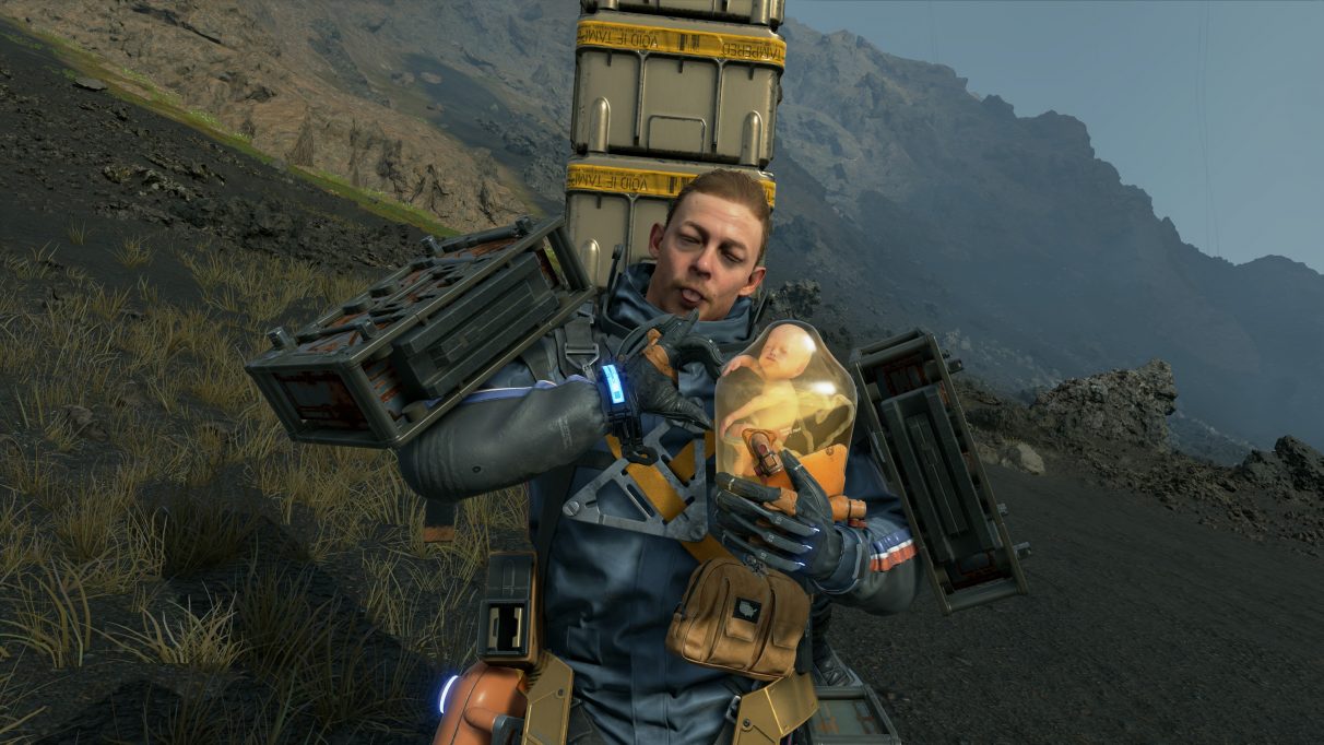 A screenshot of Sam and BB making heart signs in Death Stranding.