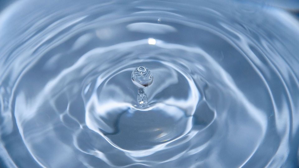 A water drop makes ripples in a pool.