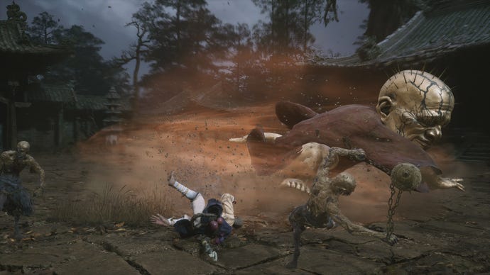 Wukong getting battered by a wandering monk boss in Black Myth Wukong.