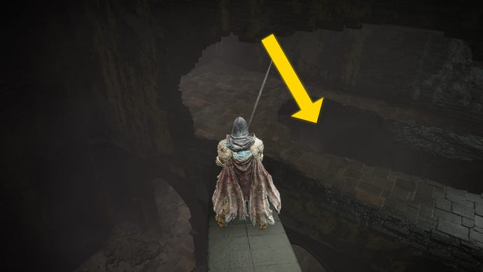 The player in Elden Ring: Shadow Of The Erdtree stands on a support strut inside the Shadow Keep Church and looks down towards a hole in the upper floor.