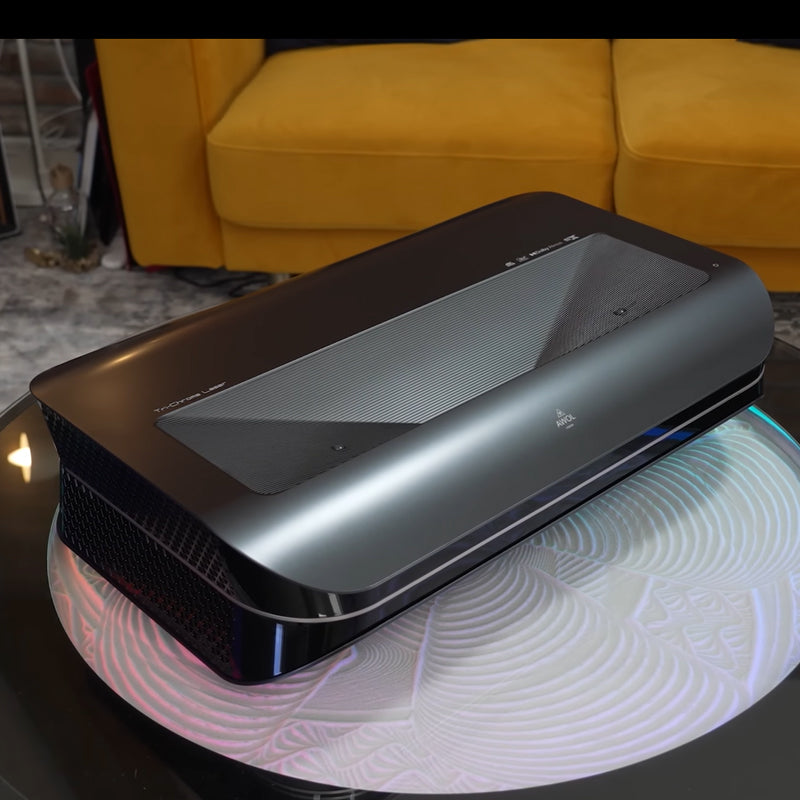 AWOL Vision LTV-3500 Pro 4K 3D Ultra Short Throw Laser UST Projector displayed in a modern living room.