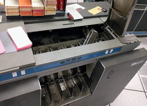 The IBM 1401's card reader was experiencing errors, so we removed the brushes and realigned them.