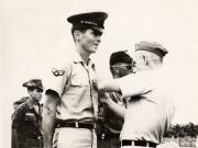 Black and white photograph of Leonard Matlovich receiving a Bronze Star in Vietnam.