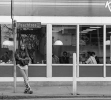 A young RuPaul leans against a Peachtree Street sign outside of a Krystal restaurant in Atlanta in 1988.