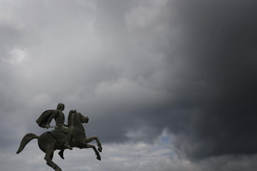 FILE- In this Wednesday, Oct, 8, 2014 file photo, a modern bronze statue of Alexander the Great stands under the cloudy sky of the northern port city of Thessaloniki, Greece. Officials in Greece and Macedonia say Tuesday, June 12, 2018, they are close to reaching a landmark deal on a long-standing name dispute, to protect Greece's region of Macedonia, birthplace of ancient warrior king Alexander the Great, but the Greek coalition partner has vowed to vote against the proposed agreement. (AP Photo/Petros Giannakouris, File)