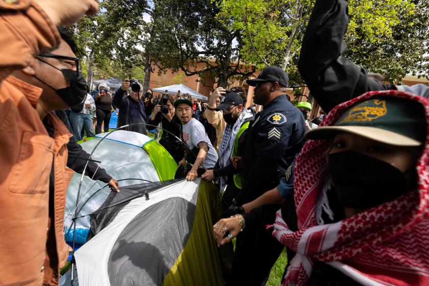 Los Angeles, CA - April 24: Campus safety officers try to confiscate tents from pro-Palestinian demonstrators at USC on Wednesday, April 24, 2024 in Los Angeles, CA. (Brian van der Brug / Los Angeles Times)