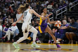 Sparks guard Rae Burrell dribbles in front of New York Liberty guard Sabrina Ionescu at Crypto.com Arena Wednesday.