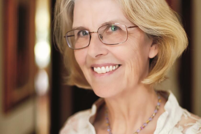 Woman wearing glasses smiles at camera