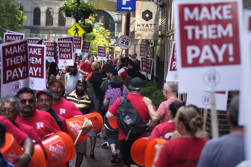 Union members from Local 26, representing workers in the hospitality industries of Massachusetts, picket outside the Hyatt Regency Boston, Wednesday, July 17, 2024, in Boston. (AP Photo/Charles Krupa)