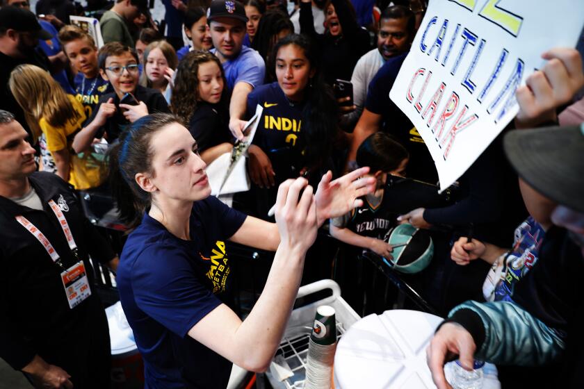 Indiana Fever guard Caitlin Clark signs autographs for fans before playing the Liberty in New York Saturday. 