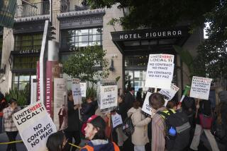 Unite Here Local 11 workers hold a rally as they protest outside the Figueroa Hotel in downtown Los Angeles on Friday, April 5, 2024. (AP Photo/Damian Dovarganes)