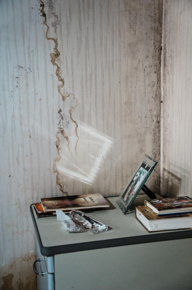 Mildew and water stain mark the wall where Ajit Roy lives.