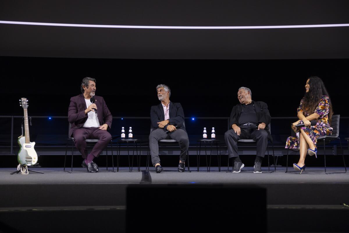 Four people participate in an onstage Q&A.