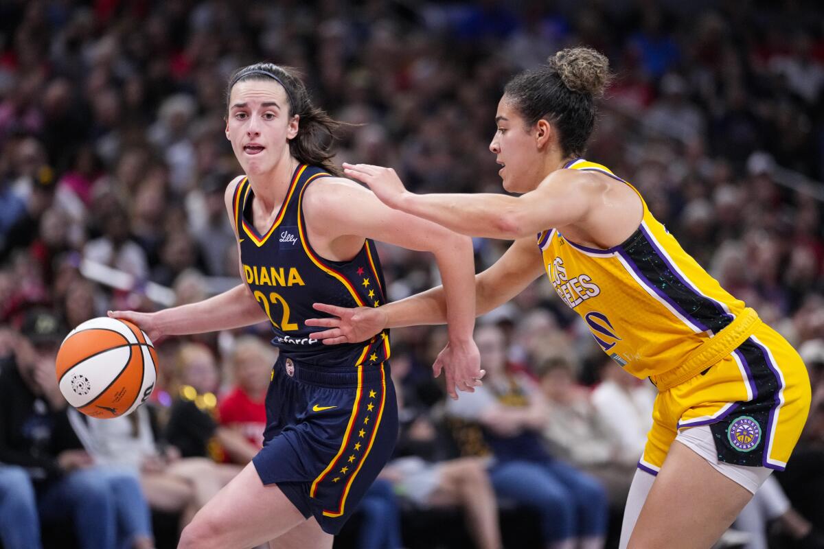 Caitlin Clark drives against Sparks guard Kia Nurse in the second half.