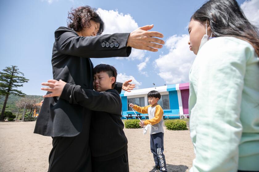 Lee Eun-sook, the principal at Dochang Elementary, comforts Han Su-hyeok, who was about to cry. The decline of South Korea' rural towns and their schools began with the country's rapid industrialization in the 1960s and 1970s, when farming and fishing villages saw a mass exodus of its young workforces to cities like Seoul. From 1982, education authorities responded to the fall in rural populations by shutting down around 5,000 elementary schools, which had become too small and too costly to maintain.