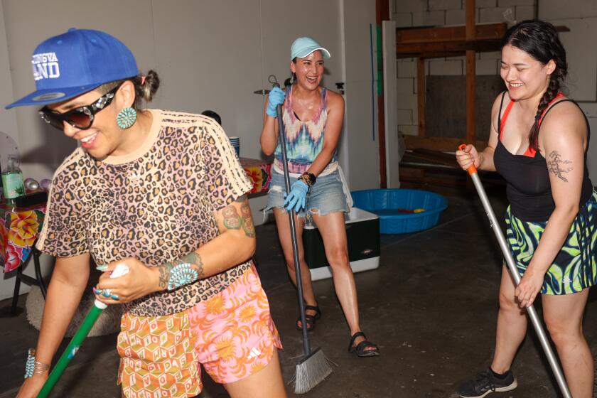 Emma Robbins, left, Burgandi Trejo Phoenix, center, and Katie Janss, right, laugh.